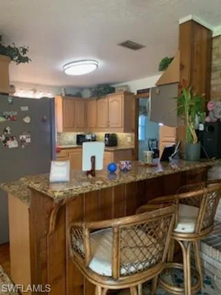 Kitchen featuring black refrigerator
