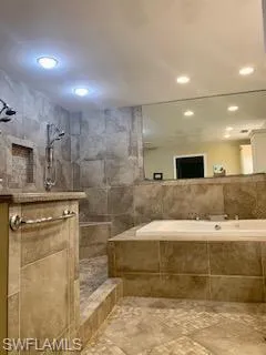 Bathroom with tile walls and a tile shower