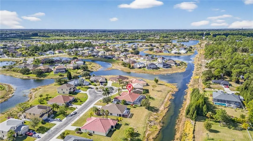 Aerial overview of property's location featuring nearby suburban area and a large body of water