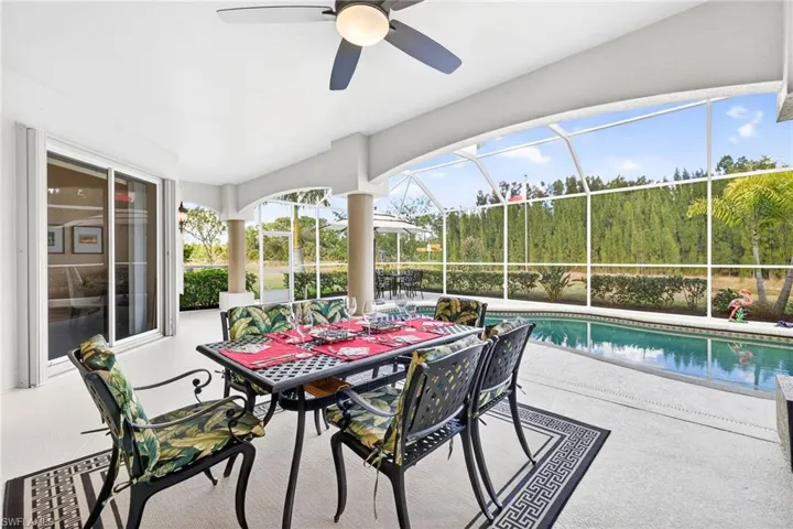 Sunroom with a patio, a ceiling fan, and outdoor dining space