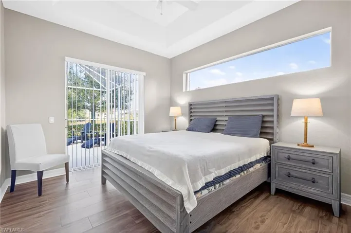 Bedroom featuring wood finished floors, access to exterior, and ceiling fan
