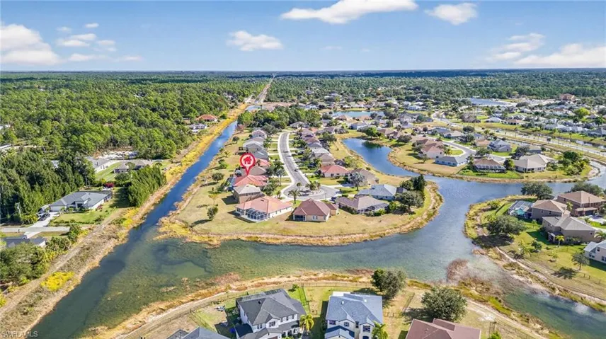 Aerial overview of property's location with nearby suburban area and a nearby body of water