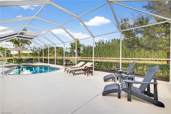 Swimming pool featuring a lanai, a sunroom, and a patio area