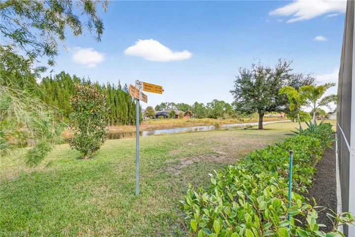 View of grassy yard with a water view