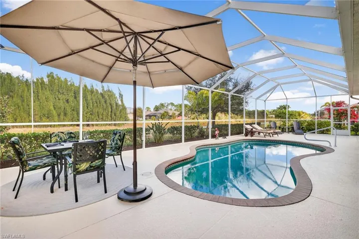 Outdoor pool featuring a patio, a sunroom, a lanai, and outdoor dining area