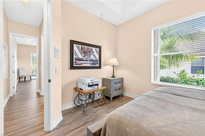 Bedroom with wood finished floors and baseboards