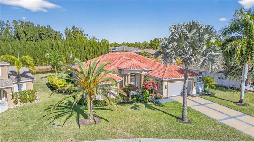 Mediterranean / spanish-style house featuring a front lawn, stucco siding, concrete driveway, a garage, and a tiled roof