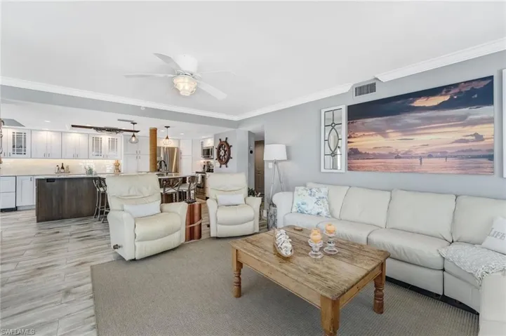 Open concept living room opens into the kitchen Island and the Lanai