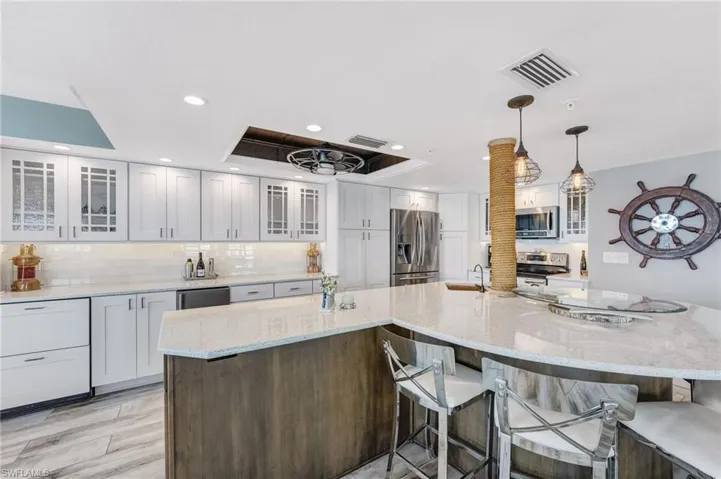 Beautiful glass cabinets, drink refrigerator and stand alone ice maker.