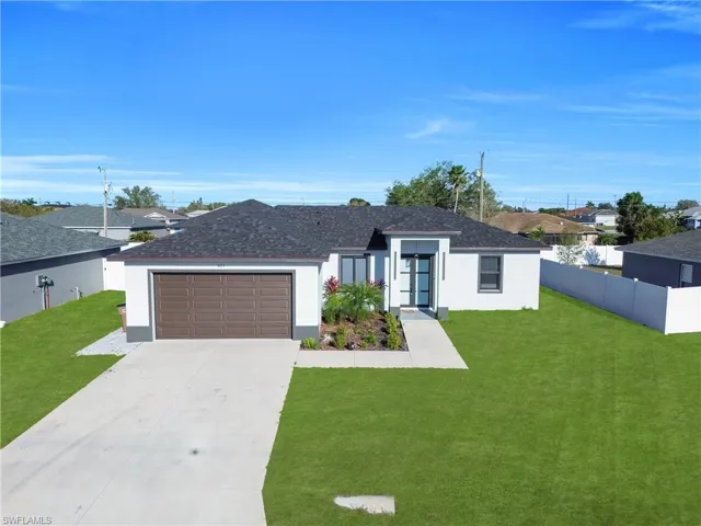Single story home featuring stucco siding, a garage, driveway, and roof with shingles
