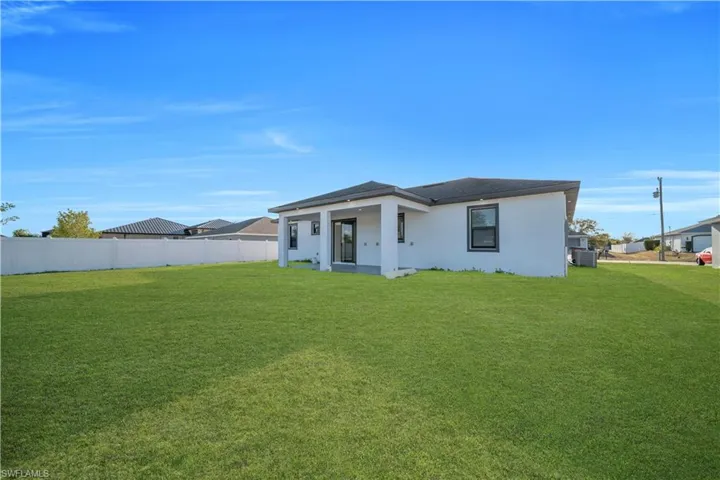 View of front of property with stucco siding and a patio area