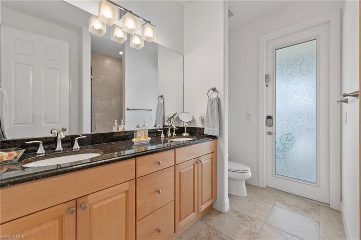 The guest bath also serves as the pool bath and offers double vanity and a walk in shower.