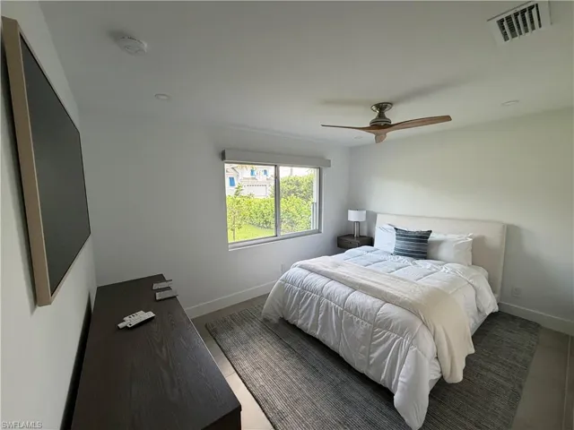 Bedroom featuring a large window, a ceiling fan, recessed lighting, and tile flooring