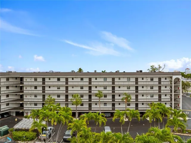 View of building 1015 G - Anglers Cove complex with uncovered parking