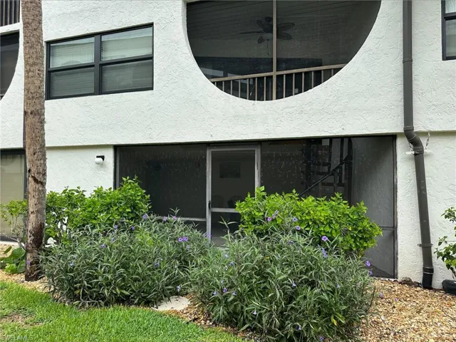 Back of house featuring stucco siding