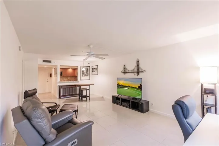 Tiled living room featuring ceiling fan