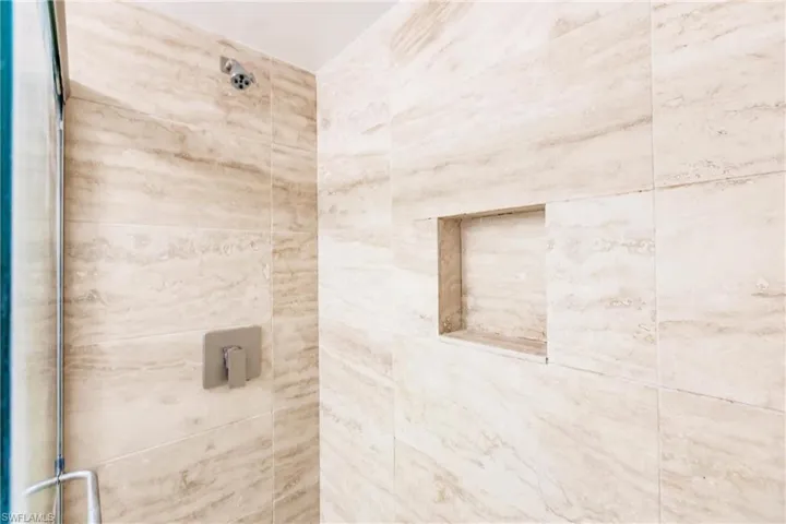 Bathroom featuring a shower with door