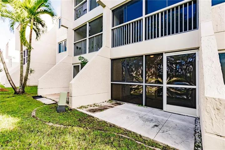 View of exterior entry featuring a yard