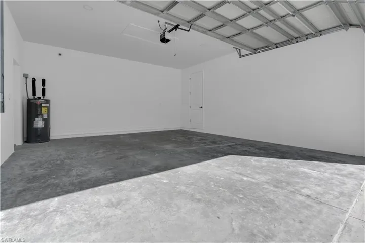 Garage featuring electric water heater