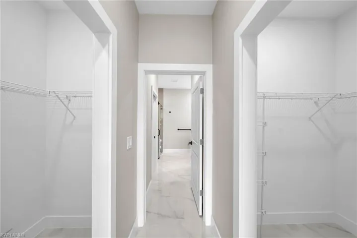Walk in closet featuring marble finish floor