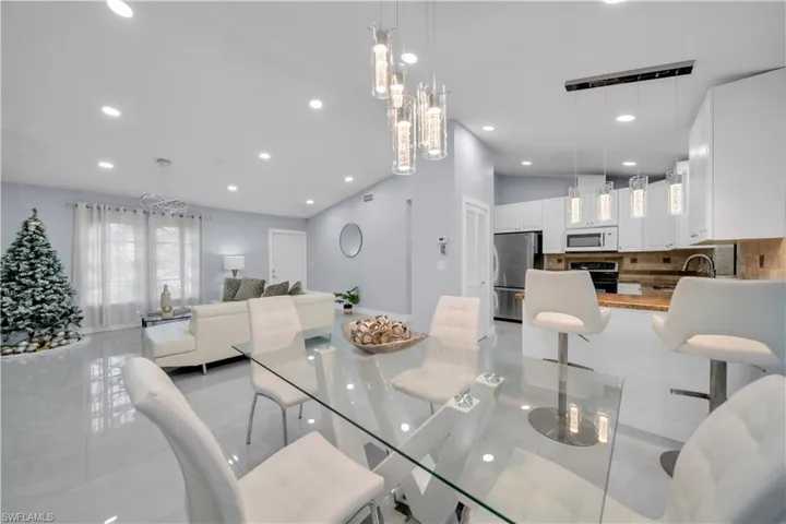 Dining area featuring recessed lighting and lofted ceiling
