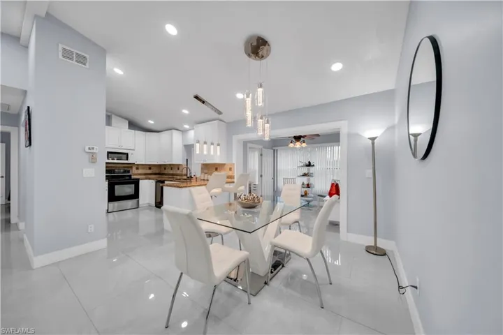 Dining area featuring a ceiling fan, vaulted ceiling, and recessed lighting
