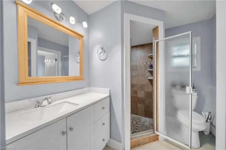 Bathroom featuring vanity and a shower stall