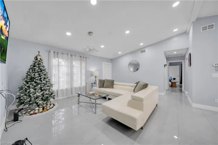 Living area with vaulted ceiling and recessed lighting