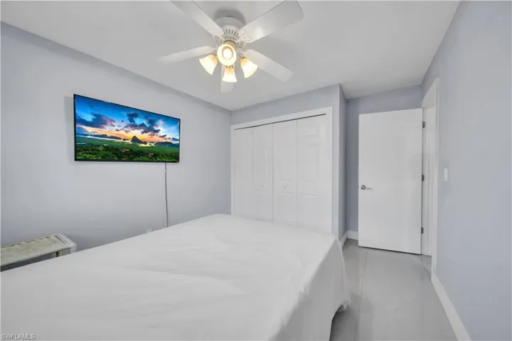 Bedroom featuring a ceiling fan and a closet