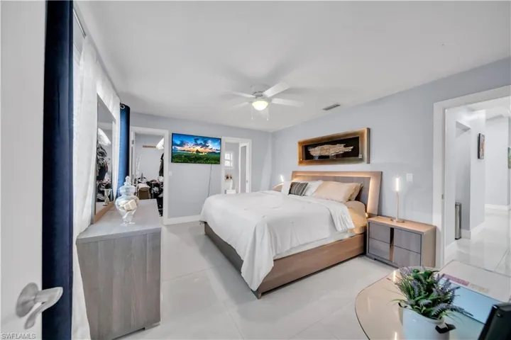 Bedroom with ensuite bathroom and a ceiling fan