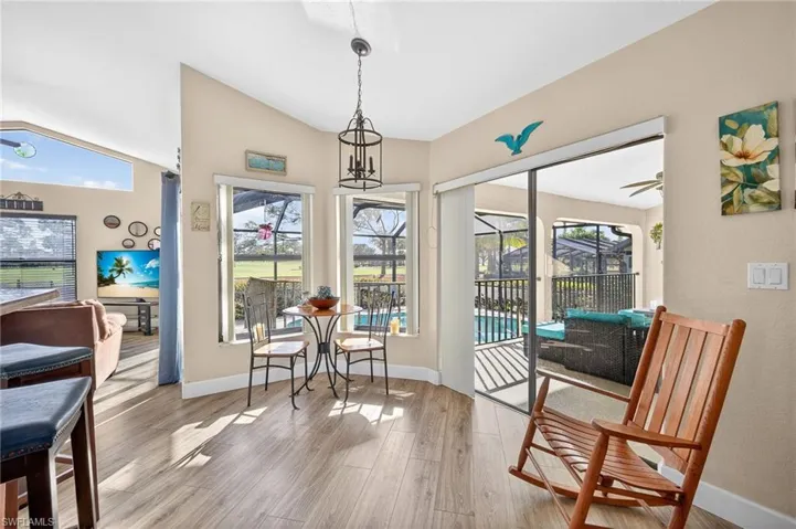 Sitting room , light wood-style floors, healthy amount of natural light, lofted ceiling, and ceiling fan