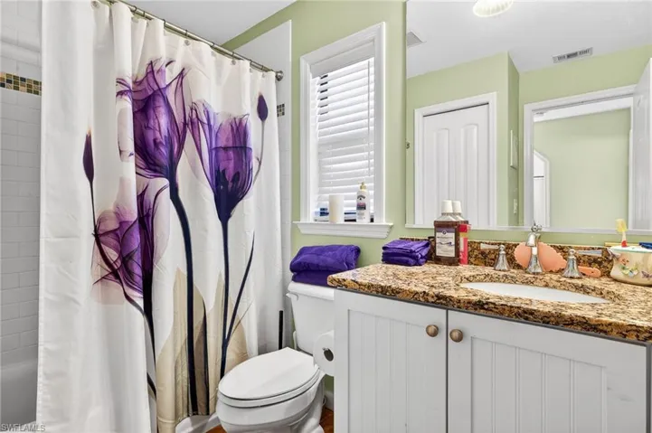Bathroom with vanity and shower / bathtub combination with curtain