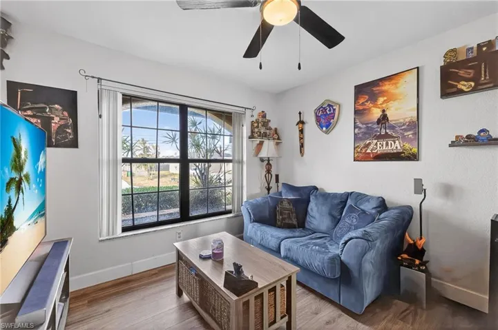 Living room featuring wood finished floors and ceiling fan