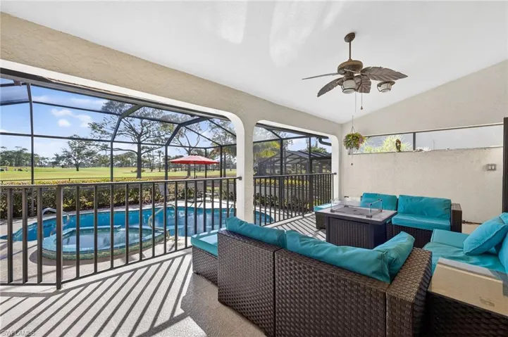 View of patio featuring screen  enclosure, a ceiling fan, a pool with connected spa , and outdoor lounge area
