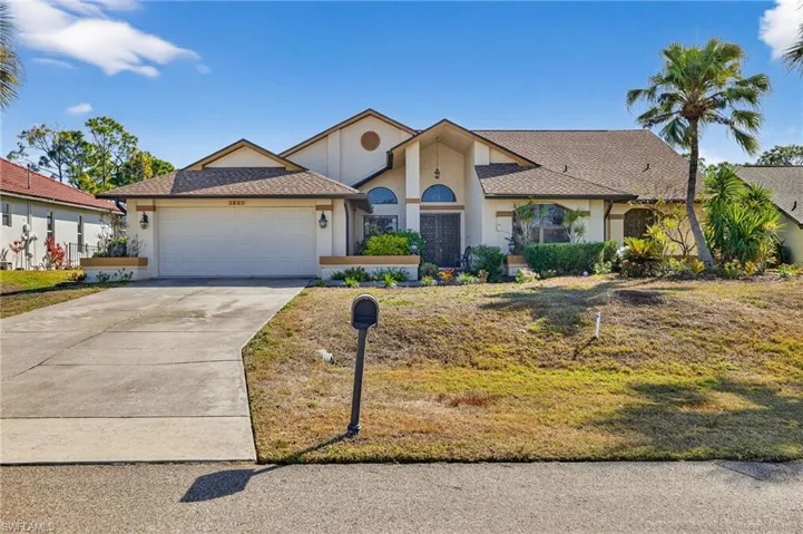 View of front facade featuring stucco siding, concrete driveway, roof with shingles, a garage, and a front yard