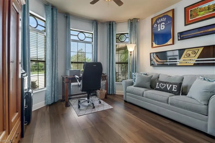 Office area featuring ceiling fan and dark hardwood / wood-style floors
