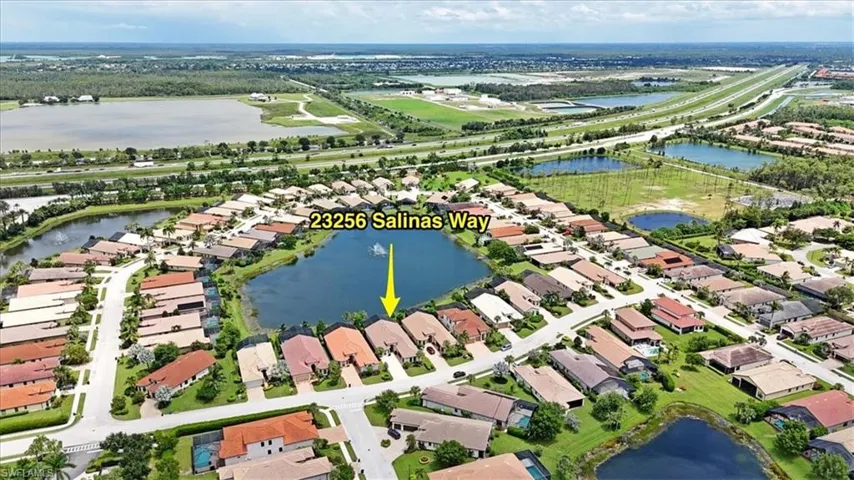 Birds eye view of property with a water view