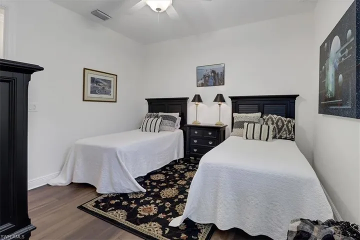 Bedroom with ceiling fan and wood-type flooring