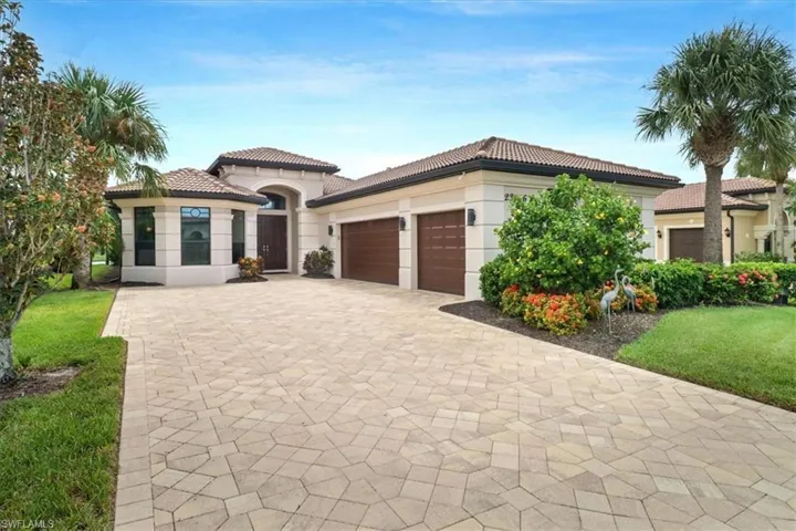 Mediterranean / spanish-style home with a garage and a front yard