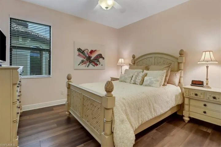 Bedroom featuring ceiling fan and dark wood-type flooring