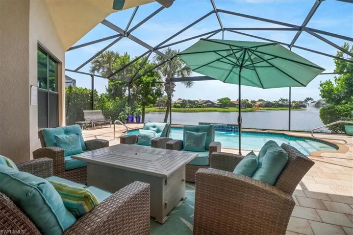 View of patio / terrace featuring an outdoor living space, a lanai, and pool water feature