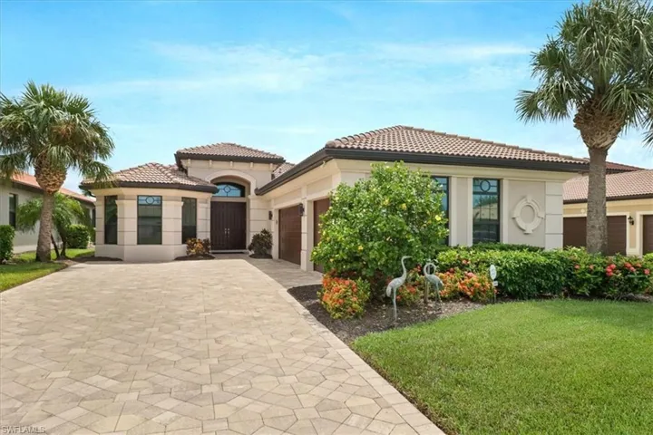 Mediterranean / spanish house featuring a garage and a front lawn