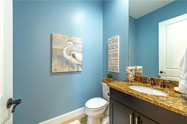 Bathroom featuring tile floors, toilet, and vanity