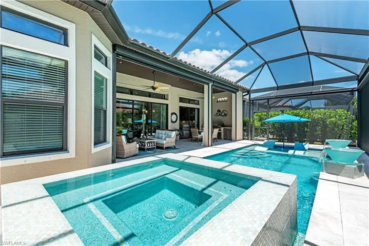 View of swimming pool with a patio area, an outdoor hangout area, ceiling fan, an in ground hot tub, and a lanai