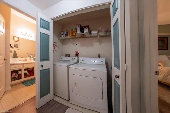 Laundry area featuring independent washer and dryer and light tile patterned floors