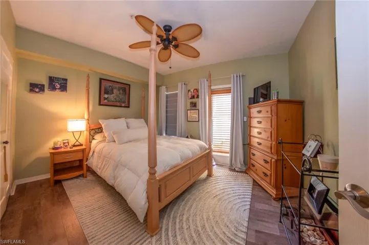 Bedroom with hardwood / wood-style flooring and ceiling fan