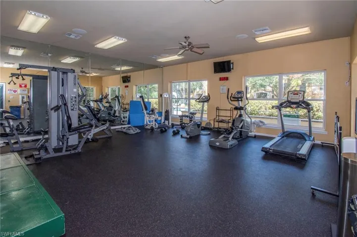 Gym with plenty of natural light and ceiling fan