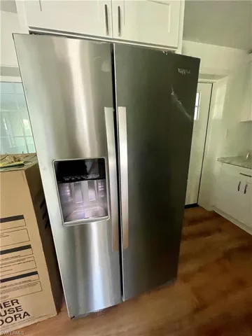 Details featuring stainless steel fridge and white cabinetry