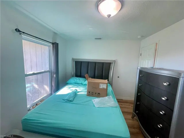Bedroom featuring dark hardwood / wood-style floors