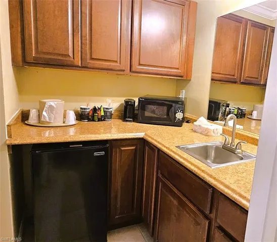 Kitchen featuring black appliances and sink